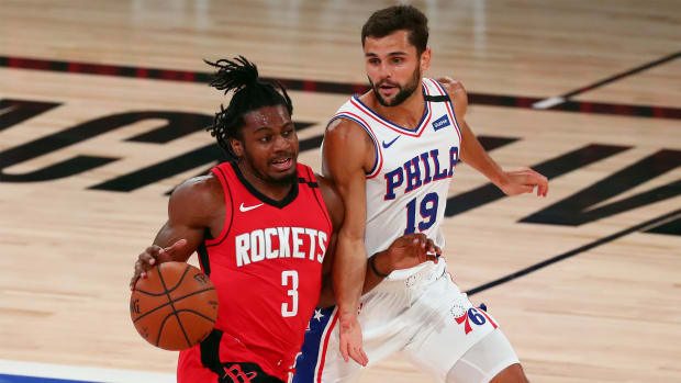 Aug 14, 2020; Lake Buena Vista, Florida, USA; Houston Rockets guard Chris Clemons (3) drives against Philadelphia 76ers guard Raul Neto (19) during the second half of a NBA basketball game at AdventHealth Arena.